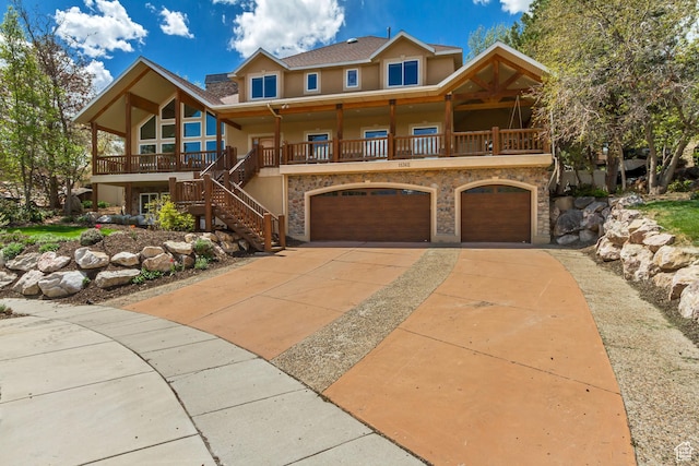 11362 Palisade View Dr, South Jordan, UT 84095 - view of front of home featuring a garage, covered porch, stucco siding, stairs, and driveway
