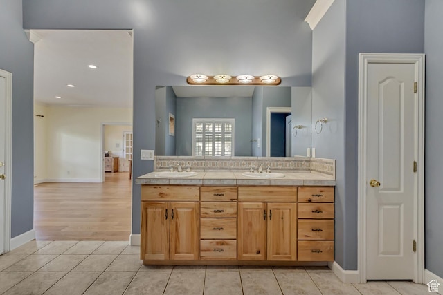 11362 Palisade View Dr, South Jordan, UT 84095 - bathroom featuring baseboards, double vanity, tile patterned floors, and a sink