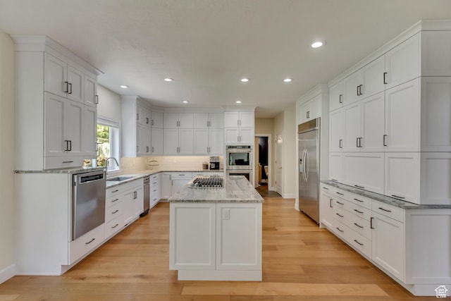 11362 Palisade View Dr, South Jordan, UT 84095 - kitchen featuring a center island, a sink, white cabinets, and stainless steel appliances