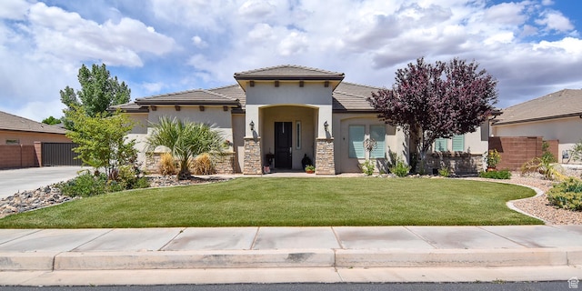 2931 E 3240 S, St George, UT 84790 - view of front of house featuring concrete driveway, a tile roof, a front yard, and stucco siding
