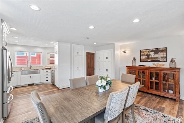 dining room with light wood-style floors and recessed lighting