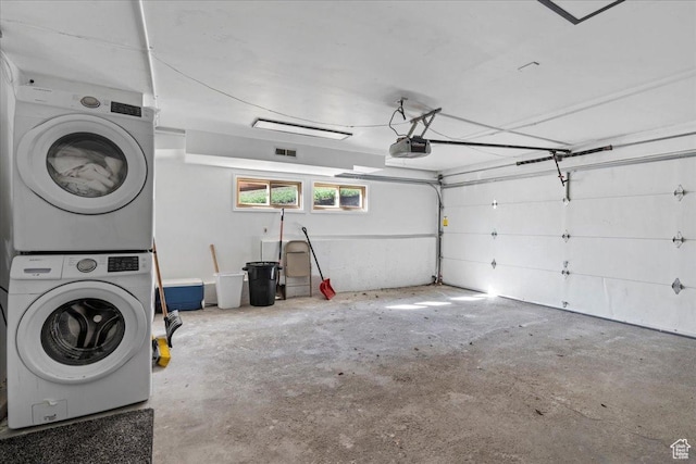 garage with a garage door opener, stacked washer / dryer, and visible vents