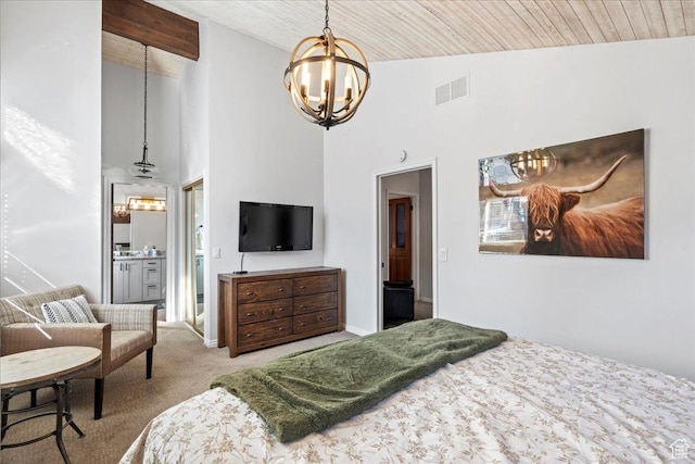 carpeted bedroom with high vaulted ceiling, visible vents, an inviting chandelier, and ensuite bath