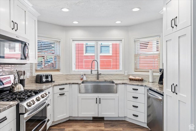 kitchen featuring a sink, appliances with stainless steel finishes, recessed lighting, and white cabinetry