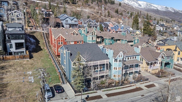 birds eye view of property with a mountain view and a residential view