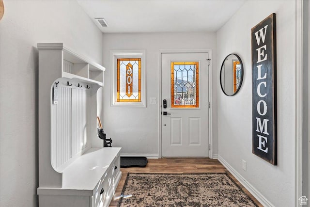 mudroom featuring baseboards, wood finished floors, and visible vents