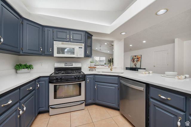 1864 S Crockett Cir, Bloomington, UT 84790 - kitchen with light tile patterned floors, appliances with stainless steel finishes, blue cabinets, and light countertops