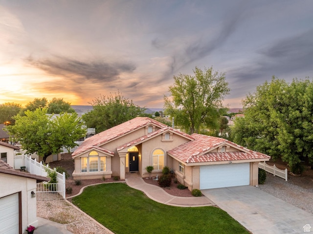 1864 S Crockett Cir, Bloomington, UT 84790 - mediterranean / spanish home with stucco siding, an attached garage, fence, and driveway