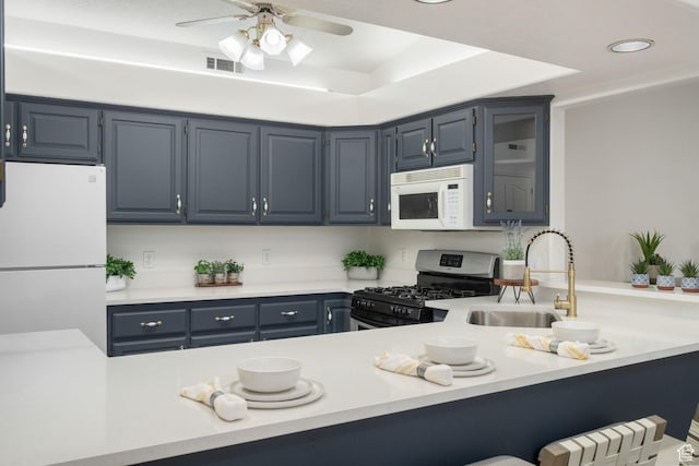 1864 S Crockett Cir, Bloomington, UT 84790 - kitchen with visible vents, a sink, white appliances, and blue cabinetry