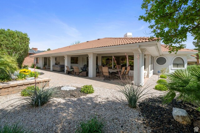 1026 Wesley Powell Dr, St George, UT 84790 - back of house featuring a patio, a chimney, a tile roof, and stucco siding