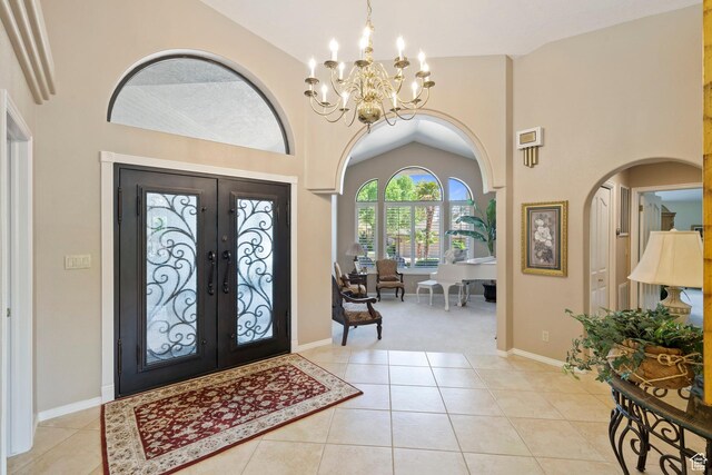 1026 Wesley Powell Dr, St George, UT 84790 - foyer entrance featuring french doors, light tile patterned flooring, high vaulted ceiling, and an inviting chandelier