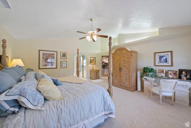 1026 Wesley Powell Dr, St George, UT 84790 - bedroom featuring ceiling fan, a textured ceiling, light colored carpet, visible vents, and vaulted ceiling