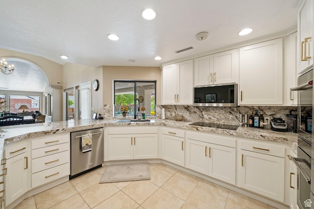 1026 Wesley Powell Dr, St George, UT 84790 - kitchen featuring a sink, appliances with stainless steel finishes, decorative backsplash, and light tile patterned flooring