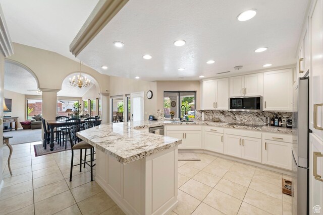 1026 Wesley Powell Dr, St George, UT 84790 - kitchen with a sink, decorative columns, appliances with stainless steel finishes, and a healthy amount of sunlight