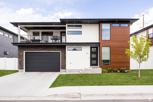 883 E Sydnee View Ln, Millcreek, UT 84107 - modern home with a front lawn, fence, a balcony, an attached garage, and driveway