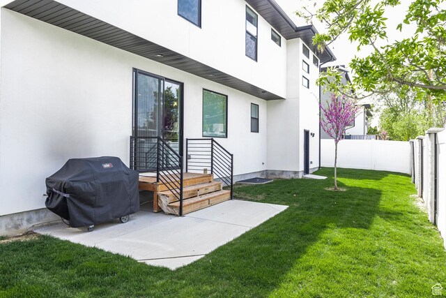 883 E Sydnee View Ln, Millcreek, UT 84107 - rear view of house with a fenced backyard, stucco siding, and a yard