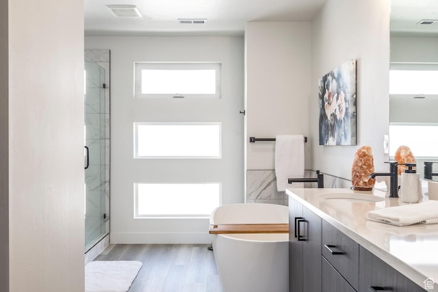 883 E Sydnee View Ln, Millcreek, UT 84107 - bathroom with a freestanding bath, a sink, a shower stall, wood finished floors, and visible vents