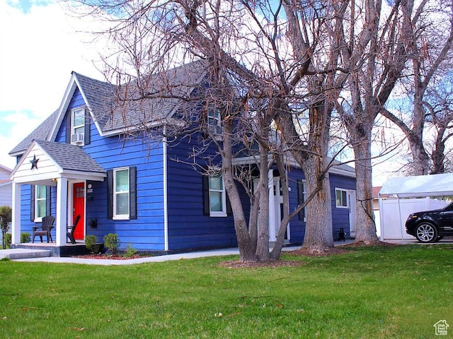 view of front facade with a front lawn, roof with shingles, and cooling unit