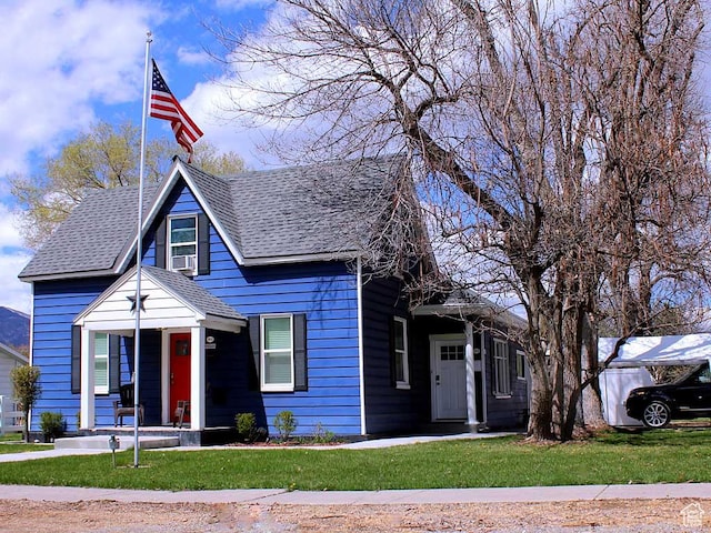 bungalow-style house with covered porch, a front yard, and roof with shingles