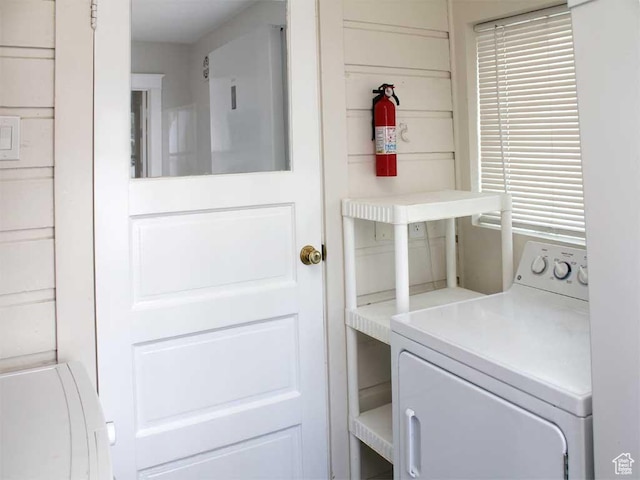 clothes washing area with laundry area and washer / dryer