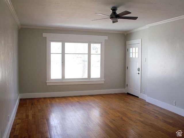 empty room with baseboards, ornamental molding, ceiling fan, and hardwood / wood-style flooring