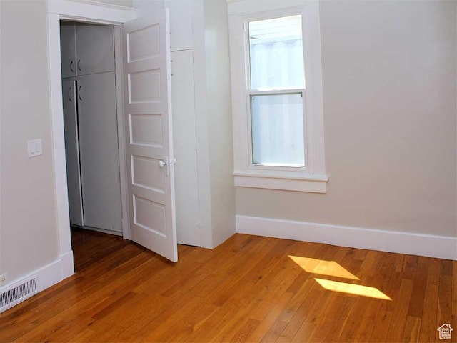 spare room with baseboards, visible vents, plenty of natural light, and light wood-style flooring