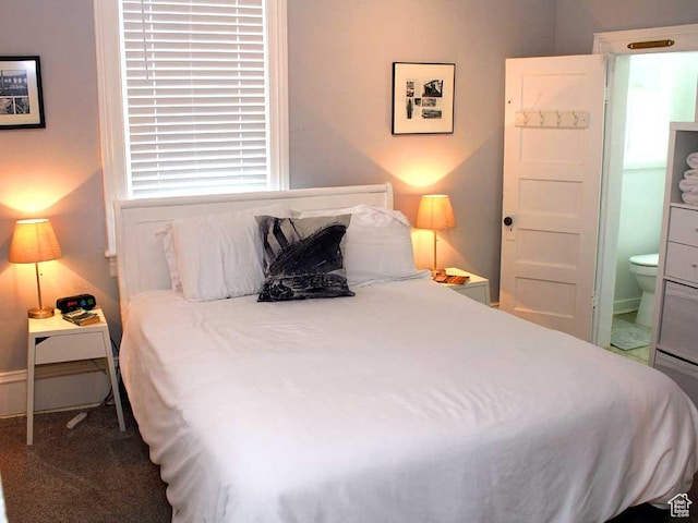 carpeted bedroom featuring ensuite bathroom