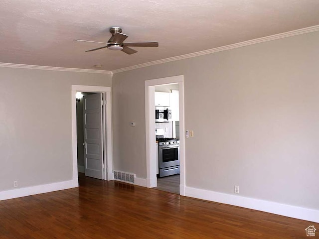 spare room featuring ceiling fan, visible vents, baseboards, and dark wood-type flooring