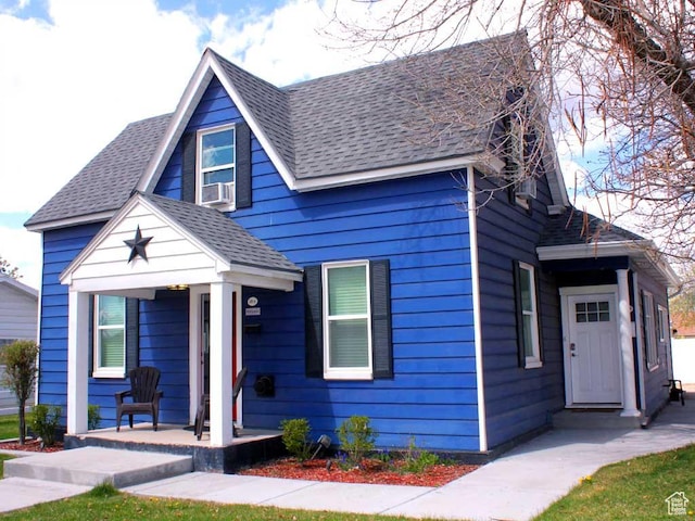 bungalow-style house featuring covered porch and roof with shingles