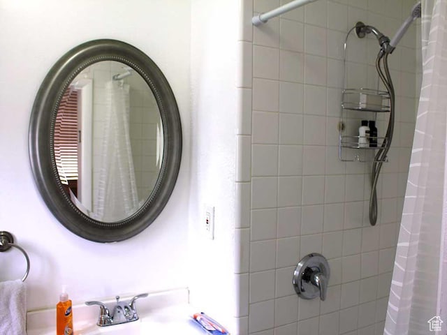 bathroom with a sink and a shower with shower curtain