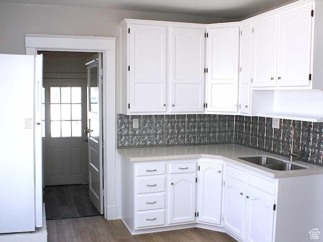 kitchen with white cabinets and freestanding refrigerator