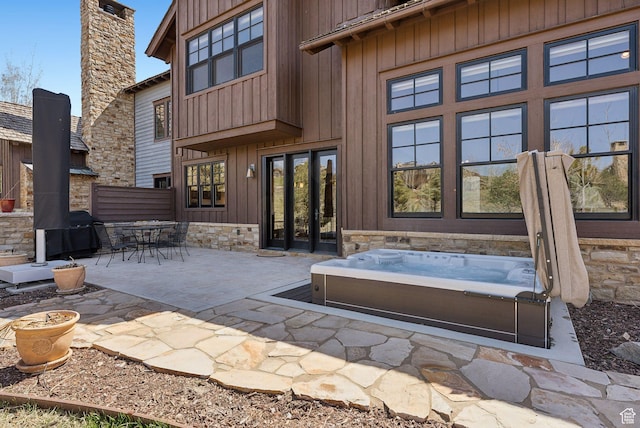 3250 E Thunderhawk Trl, Heber City, UT 84036 - rear view of property featuring a patio, board and batten siding, and an outdoor hot tub