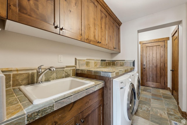 3250 E Thunderhawk Trl, Heber City, UT 84036 - laundry room with a sink, washing machine and dryer, stone finish flooring, and cabinet space
