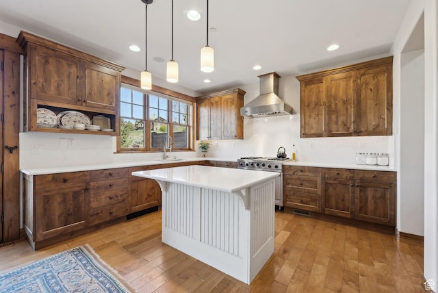 3250 E Thunderhawk Trl, Heber City, UT 84036 - kitchen featuring wall chimney range hood, stainless steel range, a sink, light countertops, and light wood-type flooring