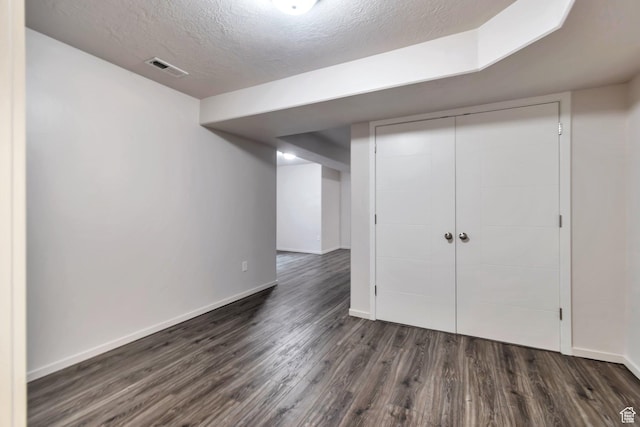11611 S Alexandria W, South Jordan, UT 84009 - finished below grade area with dark wood-type flooring, a textured ceiling, and baseboards