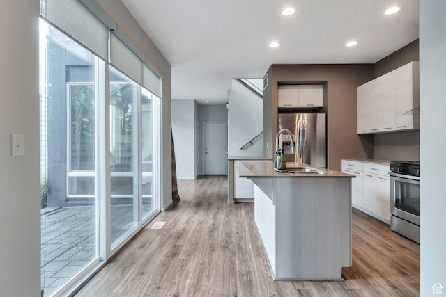 11611 S Alexandria W, South Jordan, UT 84009 - kitchen featuring white cabinets, stainless steel appliances, a sink, and modern cabinets
