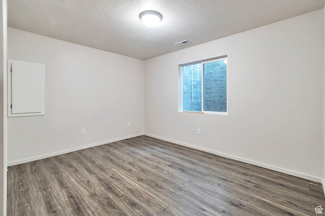 11611 S Alexandria W, South Jordan, UT 84009 - spare room featuring visible vents, a textured ceiling, and dark wood-type flooring