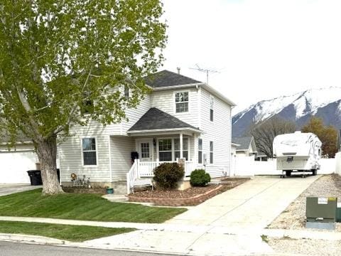 863 S 1520 E, Spanish Fork, UT 84660 - view of front of house with a mountain view, driveway, and a front yard
