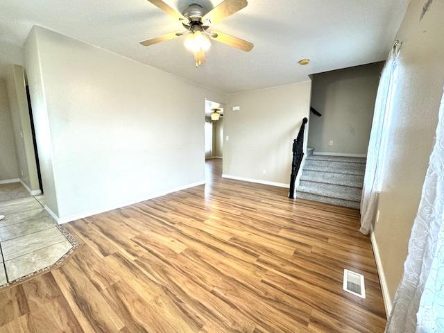 863 S 1520 E, Spanish Fork, UT 84660 - unfurnished living room featuring visible vents, light wood finished floors, ceiling fan, and stairway
