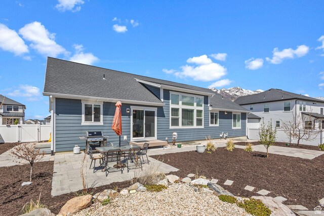 2438 E Lone Hill Dr, Draper, UT 84020 - back of house featuring fence, a gate, a patio, and roof with shingles