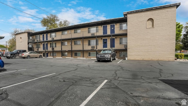 view of building exterior featuring uncovered parking