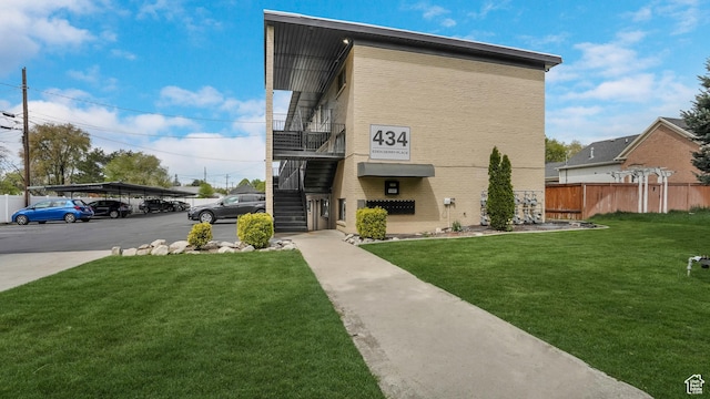 434 S 700 W Unit 4, Provo, UT 84601 - view of front of house with brick siding, fence, stairs, and a front yard