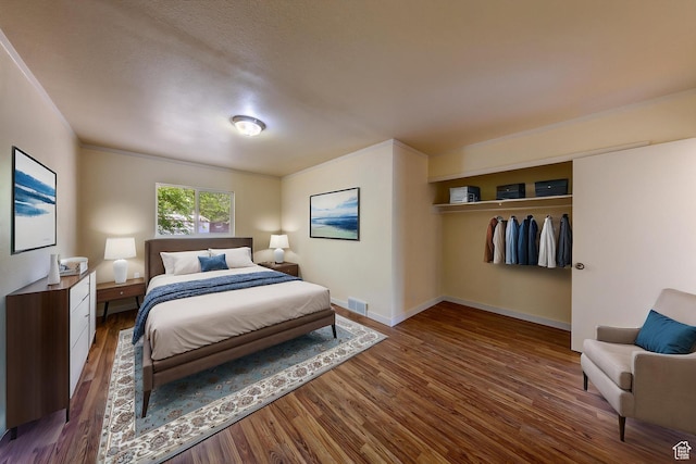 127 Birch Ave, Moab, UT 84532 - bedroom with baseboards, wood finished floors, visible vents, and a closet