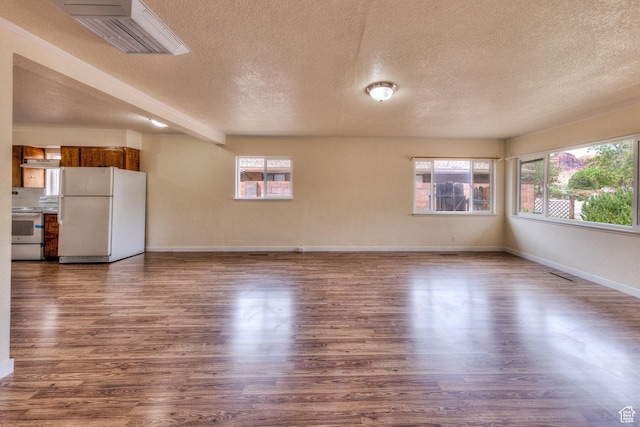 127 Birch Ave, Moab, UT 84532 - unfurnished living room with plenty of natural light, a textured ceiling, baseboards, and dark wood finished floors