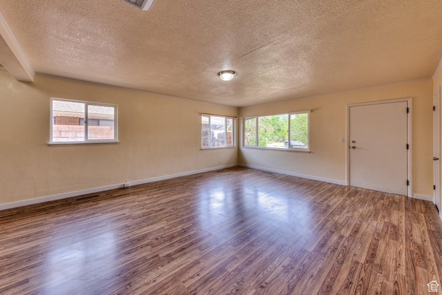 127 Birch Ave, Moab, UT 84532 - unfurnished room with baseboards, a textured ceiling, and wood finished floors
