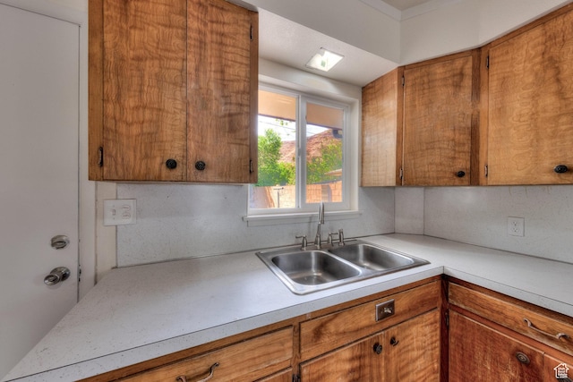 127 Birch Ave, Moab, UT 84532 - kitchen featuring light countertops, brown cabinetry, and a sink
