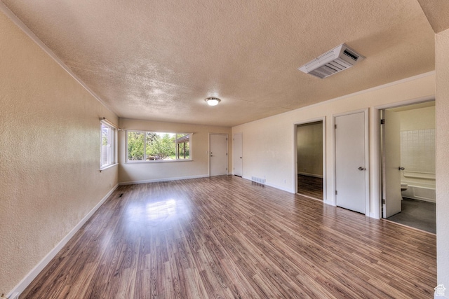 127 Birch Ave, Moab, UT 84532 - unfurnished room with baseboards, a textured ceiling, a textured wall, and wood finished floors