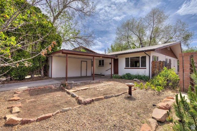 127 Birch Ave, Moab, UT 84532 - ranch-style house with driveway, metal roof, concrete block siding, and a carport