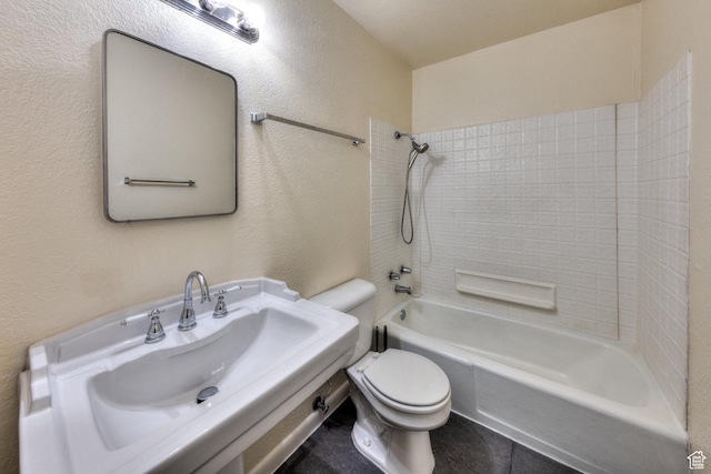 127 Birch Ave, Moab, UT 84532 - bathroom with a sink, a textured wall, toilet, and shower / washtub combination