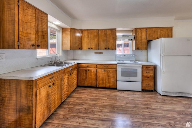 127 Birch Ave, Moab, UT 84532 - kitchen with brown cabinetry, a sink, light countertops, under cabinet range hood, and white appliances
